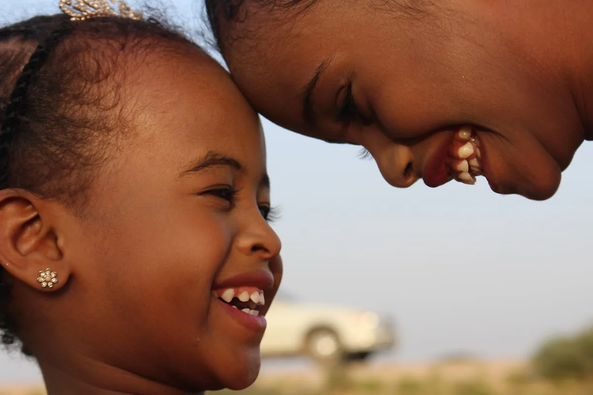 A parent and child laughing together