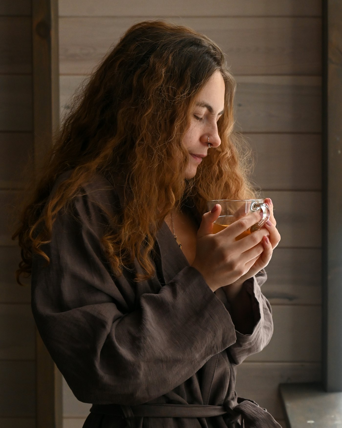 A woman relaxing in a cozy robe